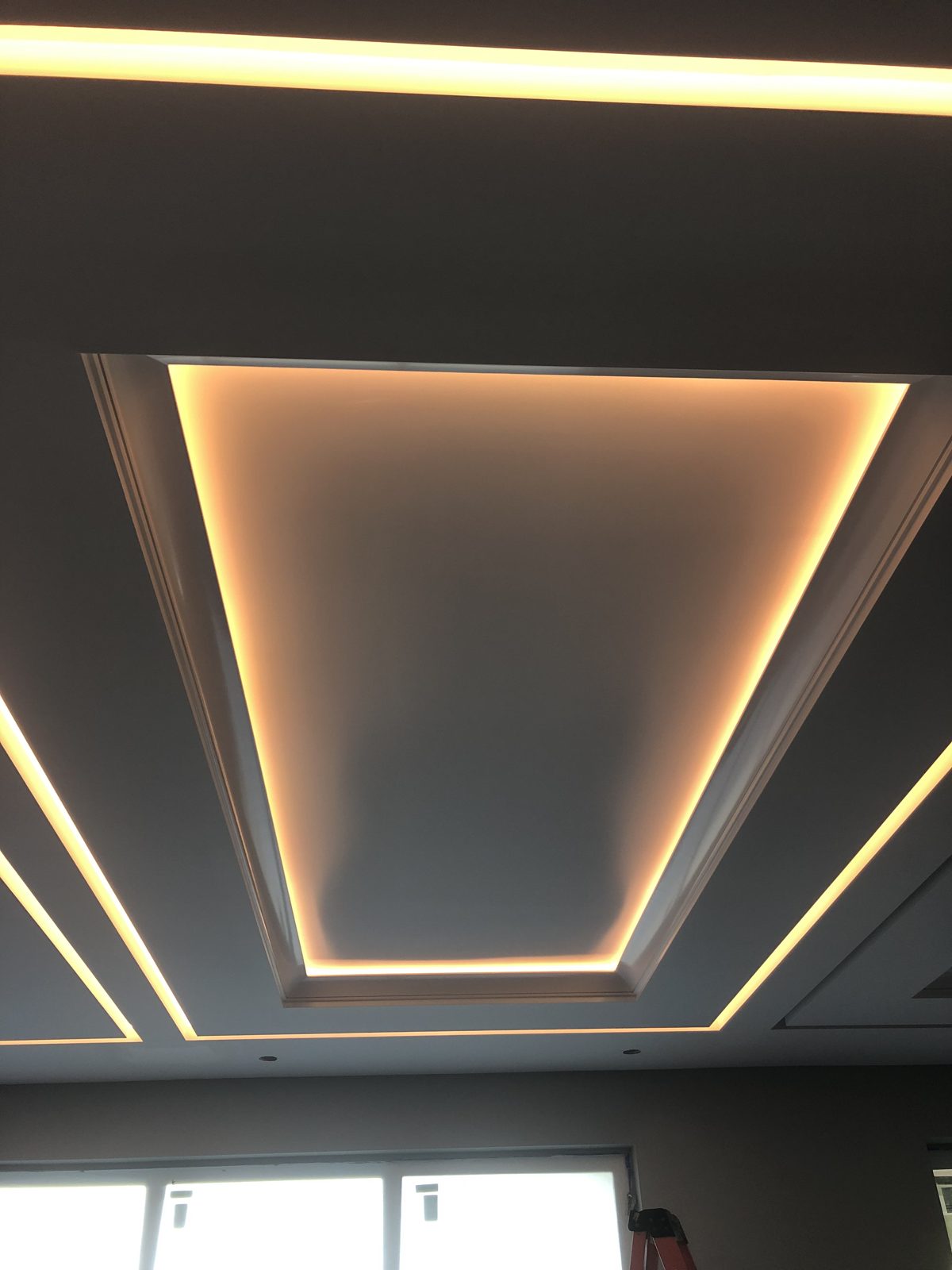 Recessed tray ceiling with warm hidden cove lighting