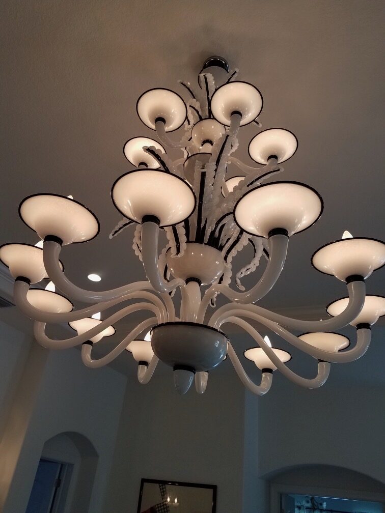 White glass Murano-style chandelier installed on a high ceiling