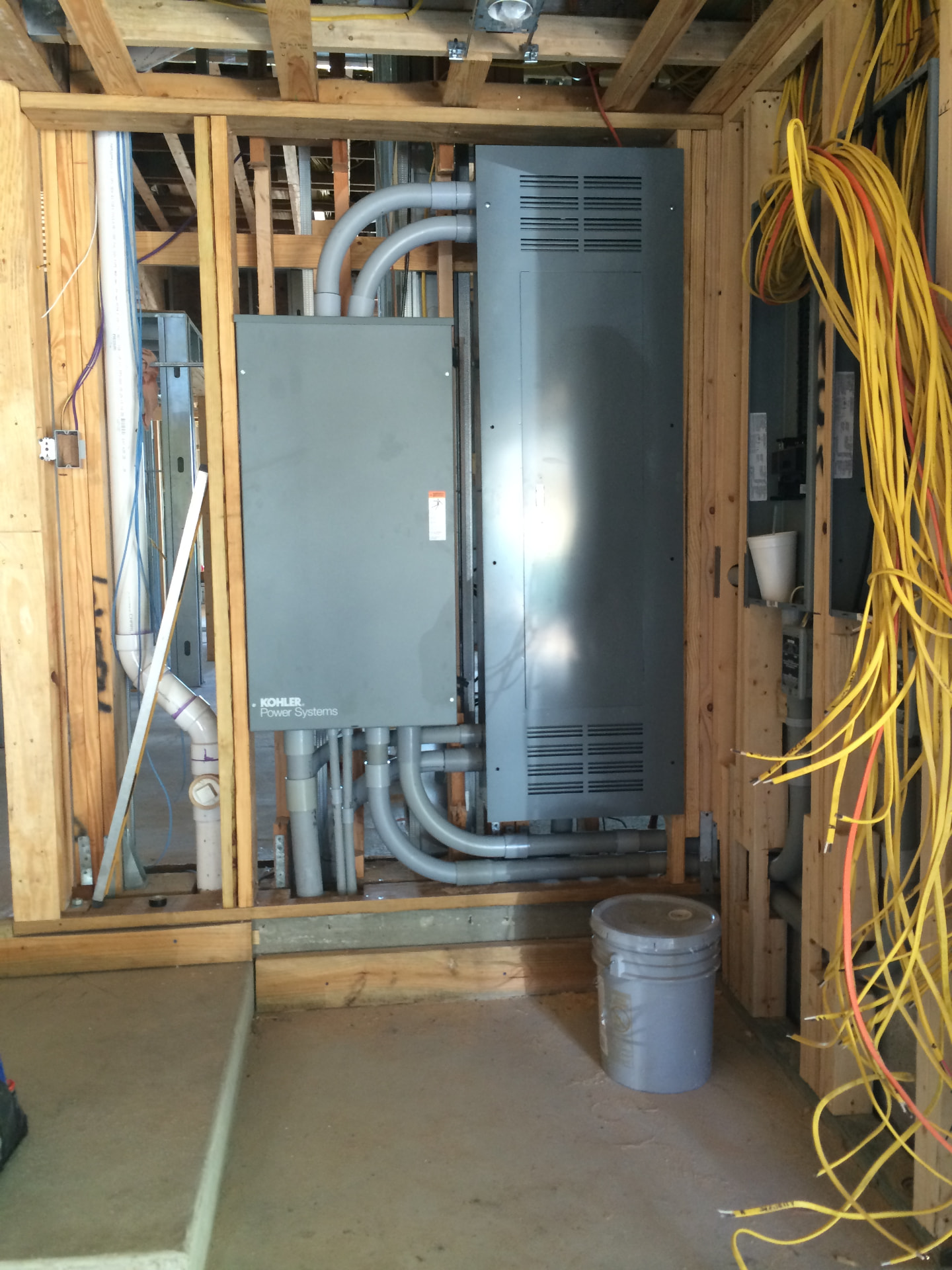 Standby generator transfer switch and service gear roughed in on a framed wall